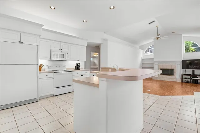 a kitchen with cabinets and white appliances