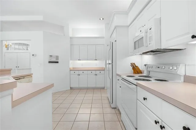 a kitchen with stainless steel appliances a sink stove and cabinets