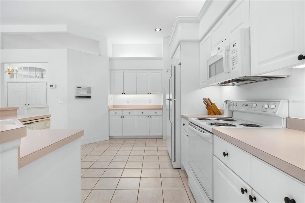 2810 89th Avenue East Parrish, FL 34219 - Photo 17 of 34 a kitchen with stainless steel appliances a sink stove and cabinets