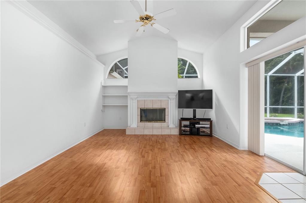 2810 89th Avenue East Parrish, FL 34219 - Photo 20 of 34 a view of empty room with fireplace and wooden floor