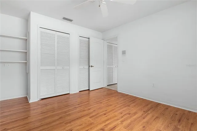 a view of empty room with wooden floor
