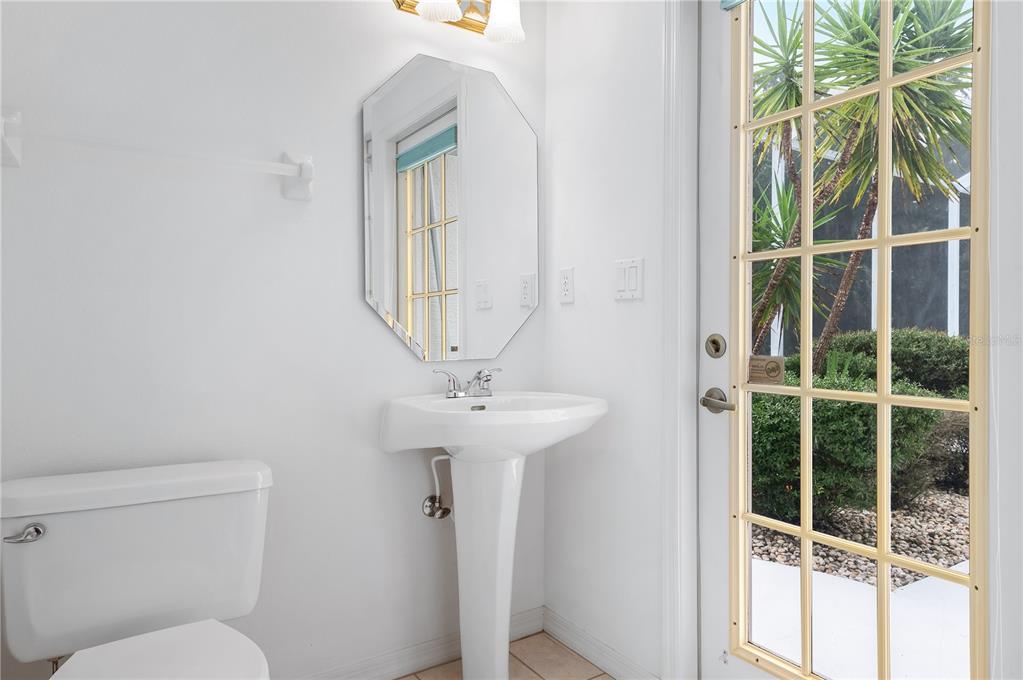 2810 89th Avenue East Parrish, FL 34219 - Photo 24 of 34 a bathroom with a toilet a sink and a mirror