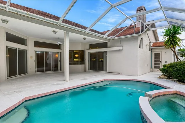 a view of an house with backyard space and swimming pool
