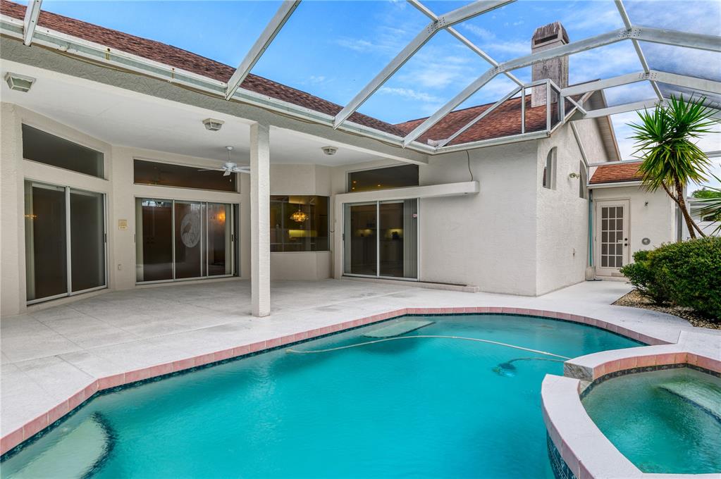 2810 89th Avenue East Parrish, FL 34219 - Photo 33 of 34 a view of an house with backyard space and swimming pool