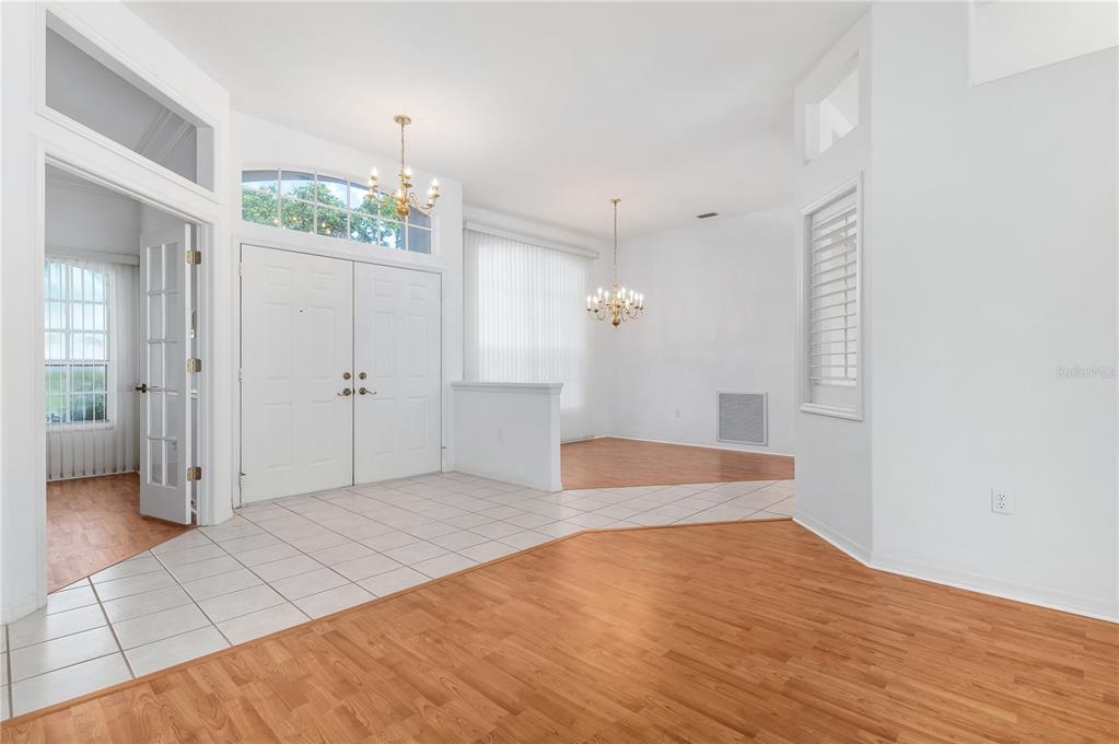 2810 89th Avenue East Parrish, FL 34219 - Photo 7 of 34 a view of an empty room with wooden floor and a bathroom