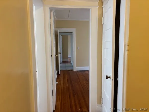 a view of a hallway with wooden floor