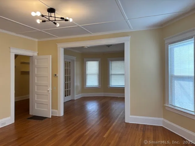 wooden floor in an empty room with a window
