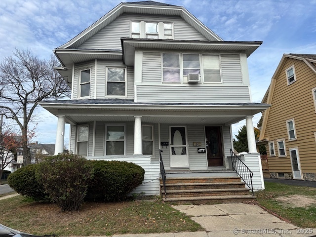 64 Wade Street, Unit 1 Bridgeport, CT 06604 - Photo 2 of 22 a view of a white house with large windows and a small yard