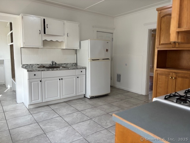 64 Wade Street, Unit 1 Bridgeport, CT 06604 - Photo 5 of 22 a kitchen with stainless steel appliances granite countertop a refrigerator and a stove top oven