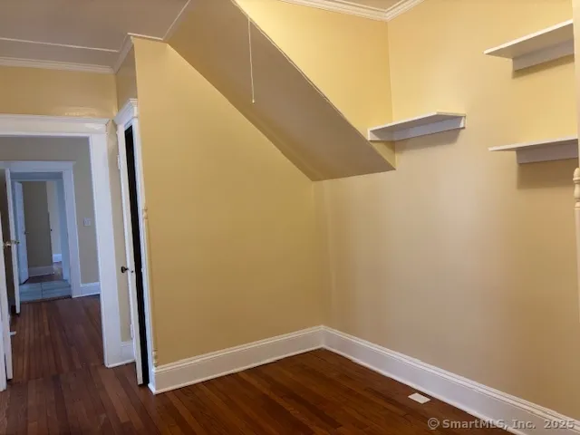 a view of a hallway with wooden floor