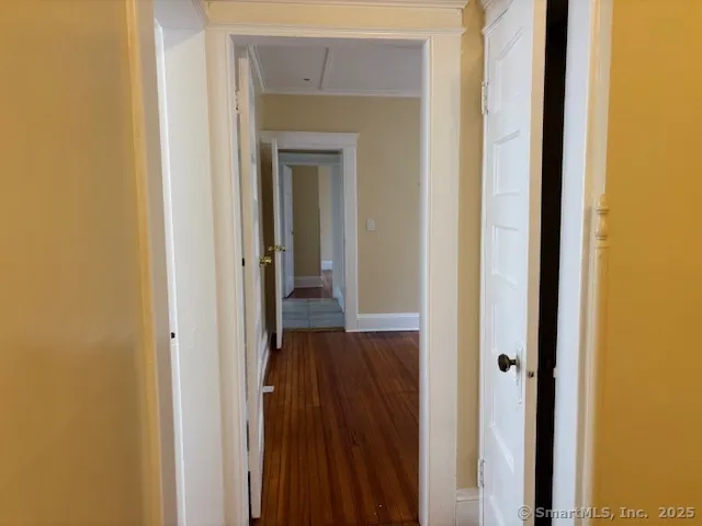 a view of a hallway with wooden floor