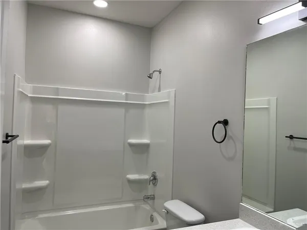 a bathroom with a shower and a toilet