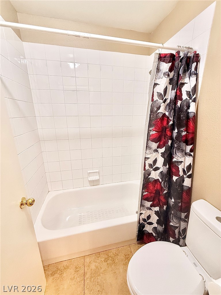 4313 Ranch Foreman Road North Las Vegas, NV 89032 - Photo 19 of 27 Crisp white wall tile surrounds a classic soaking tub paired with neutral floor tiles.