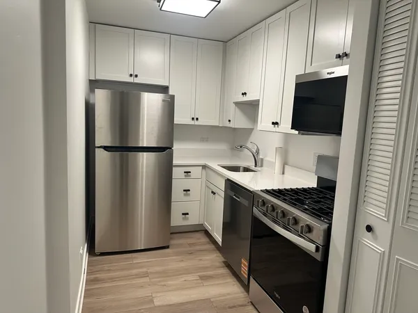 a kitchen with stainless steel appliances a refrigerator stove and microwave