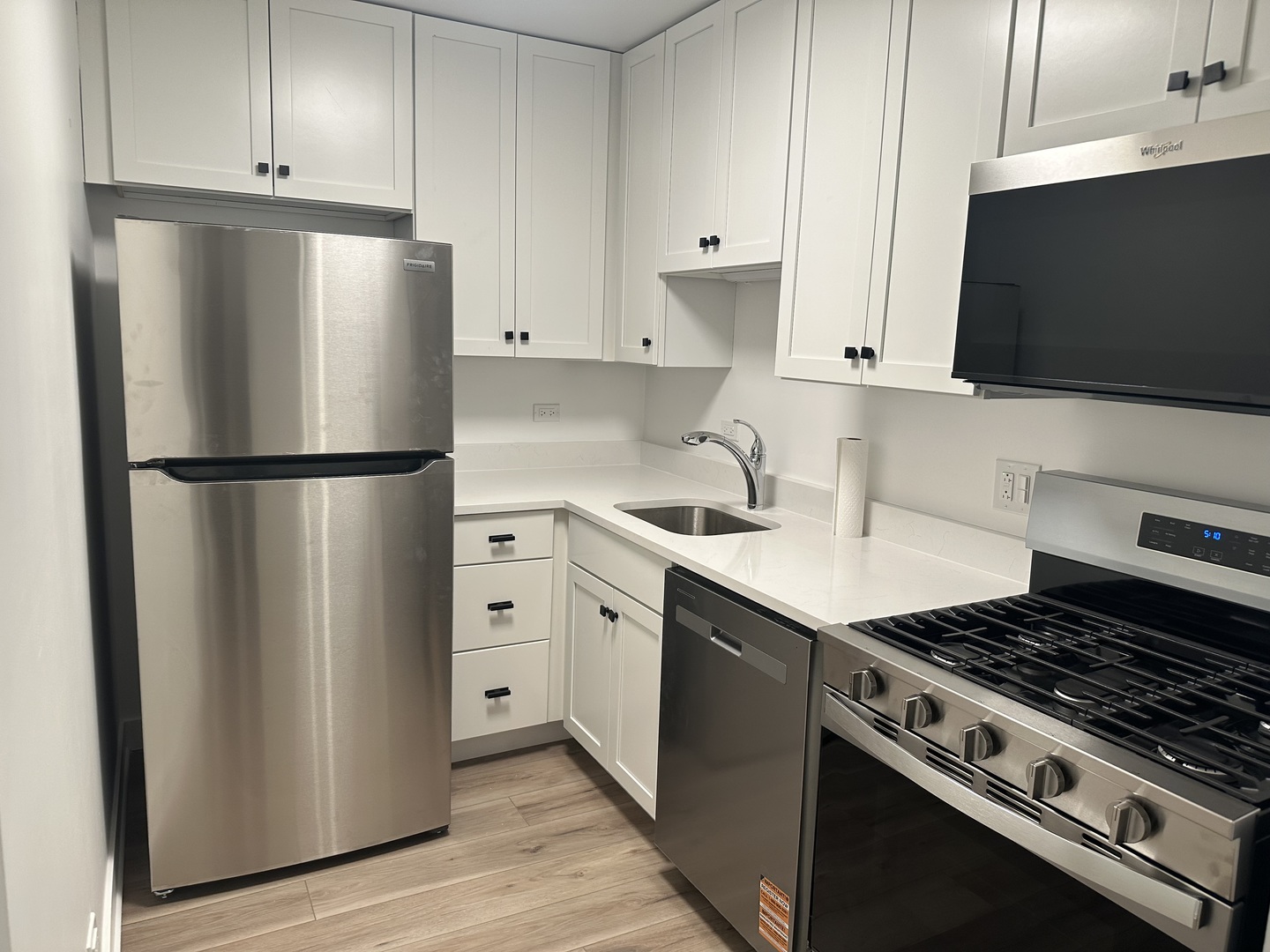 8232 Niles Center Road, Unit 202 Skokie, IL 60077 - Photo 4 of 8 a kitchen with stainless steel appliances a refrigerator stove and microwave