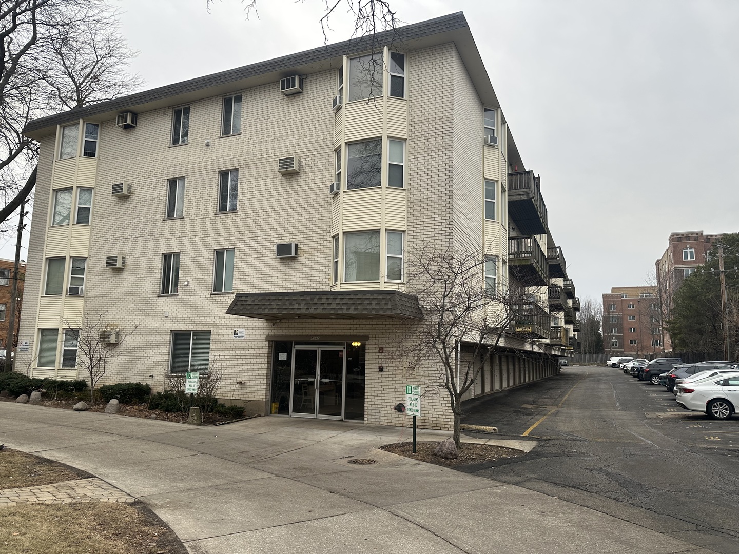 8232 Niles Center Road, Unit 202 Skokie, IL 60077 - Photo 8 of 8 a front view of a building with parking