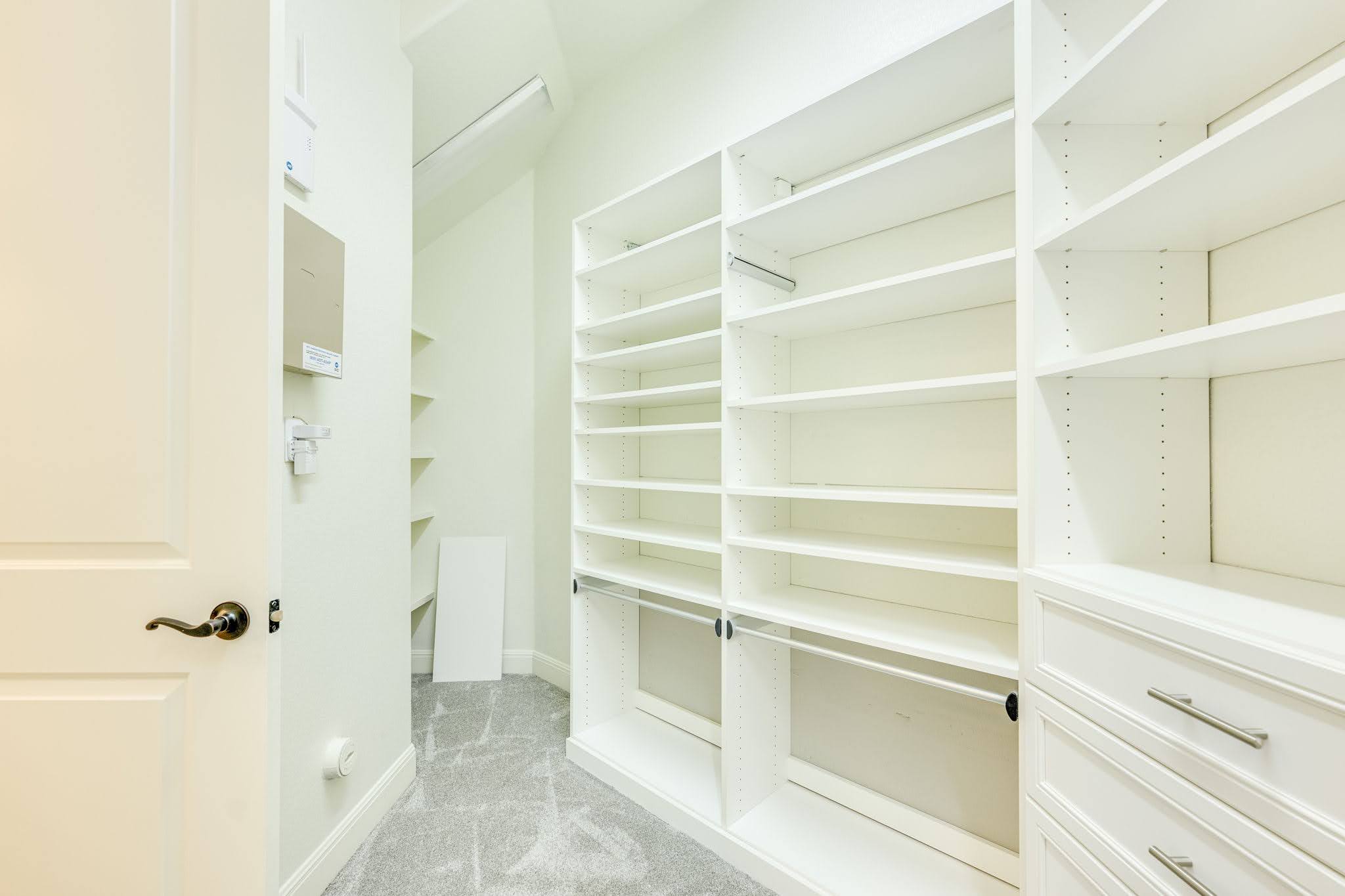 11612 Shoreview Overlook Austin, TX 78732 - Photo 31 of 40 Floor-to-ceiling custom shelving and soft carpeting define this organized closet space.