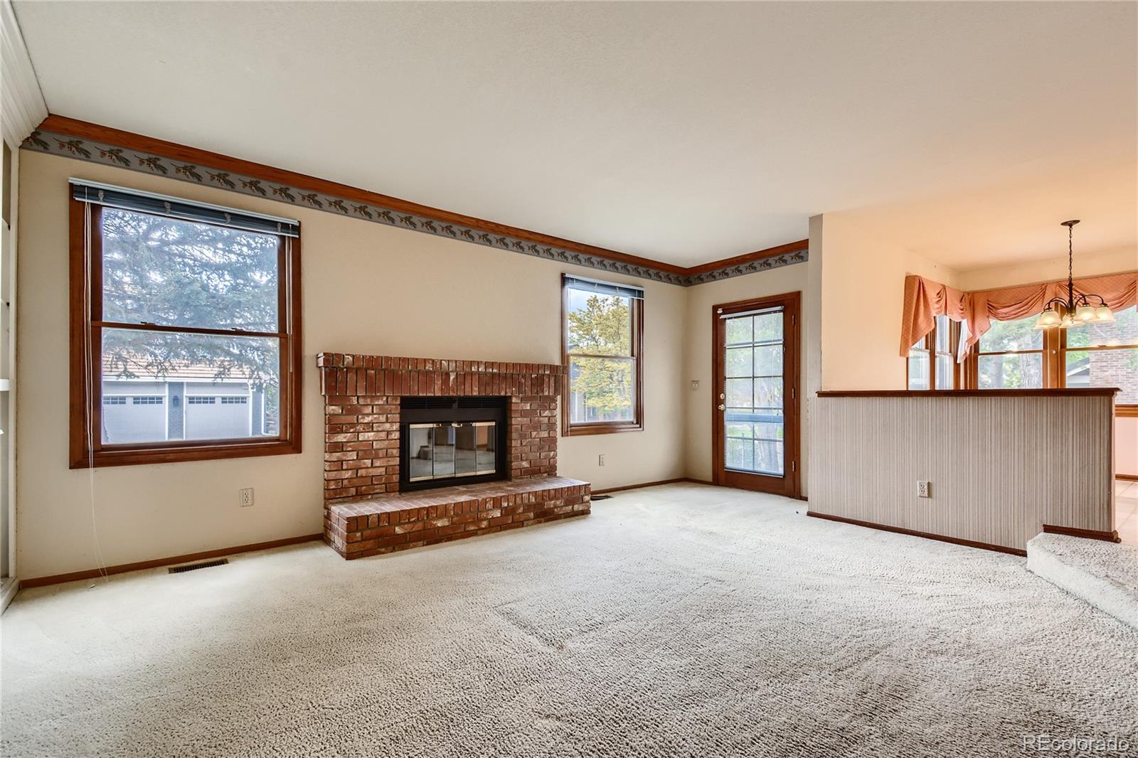 7 Red Maple Place Littleton, CO 80127 - Photo 11 of 28 an empty room with furniture and a fireplace