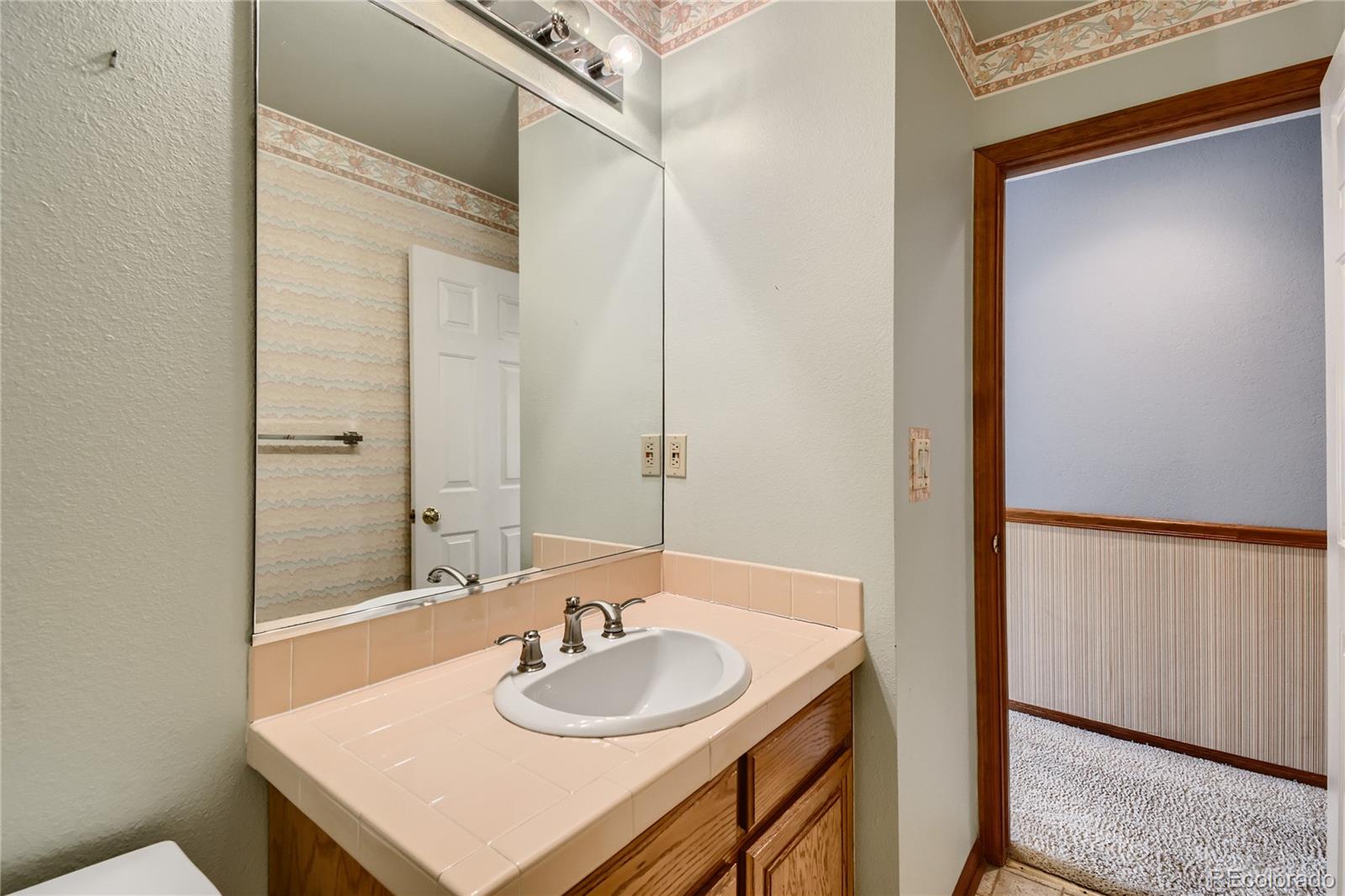 7 Red Maple Place Littleton, CO 80127 - Photo 13 of 28 a bathroom with a sink and a mirror