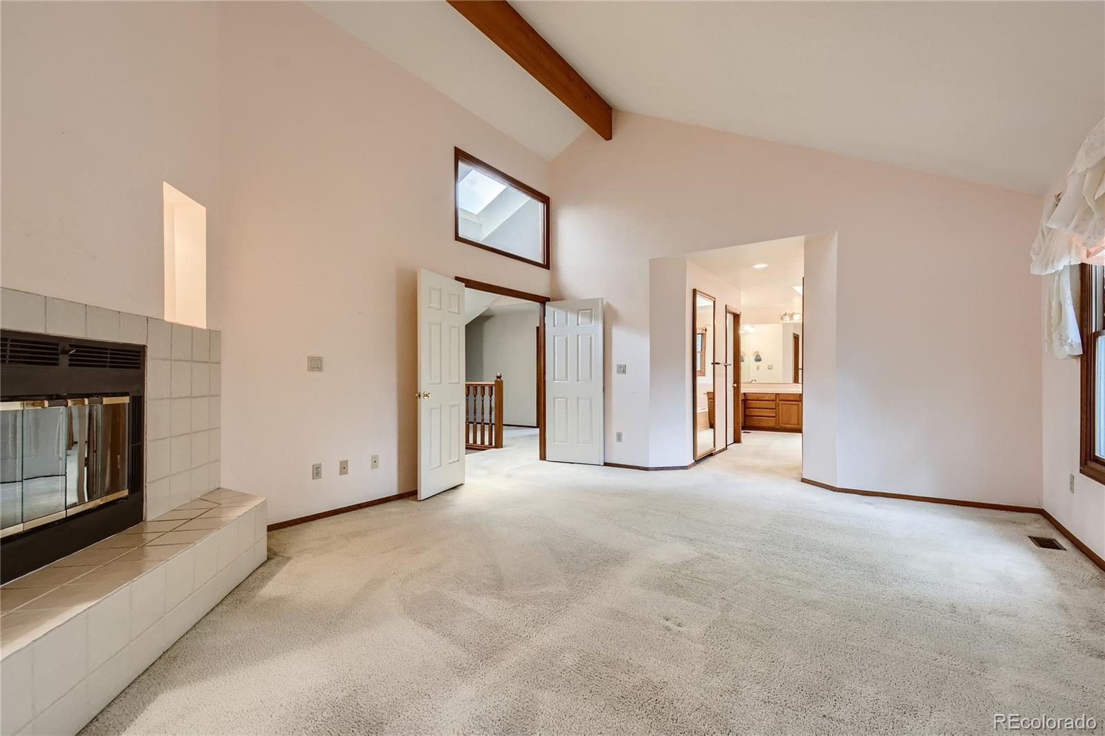 7 Red Maple Place Littleton, CO 80127 - Photo 15 of 28 a view of an empty room with window and fireplace