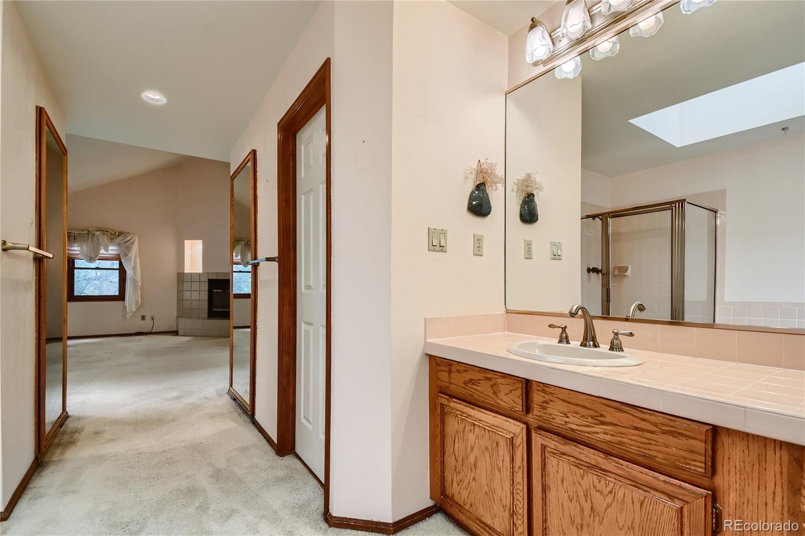 7 Red Maple Place Littleton, CO 80127 - Photo 16 of 28 a en suite bathroom with a sink double vanity and a mirror