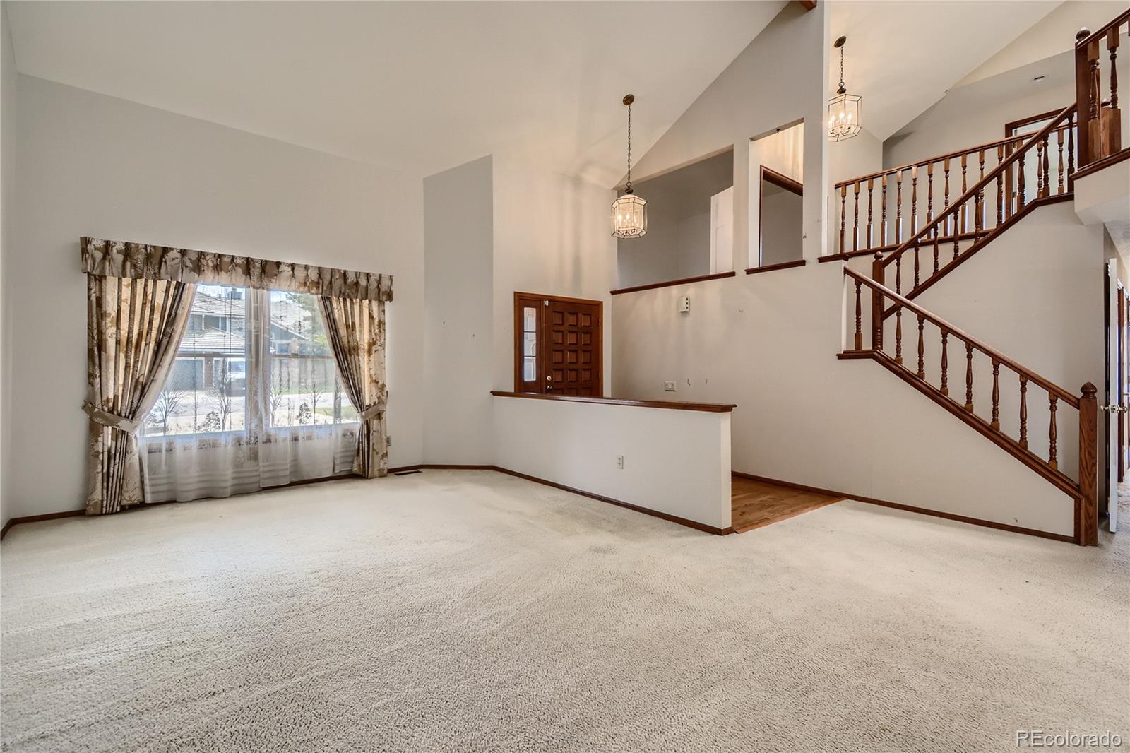 7 Red Maple Place Littleton, CO 80127 - Photo 5 of 28 a view of an empty room with stairs