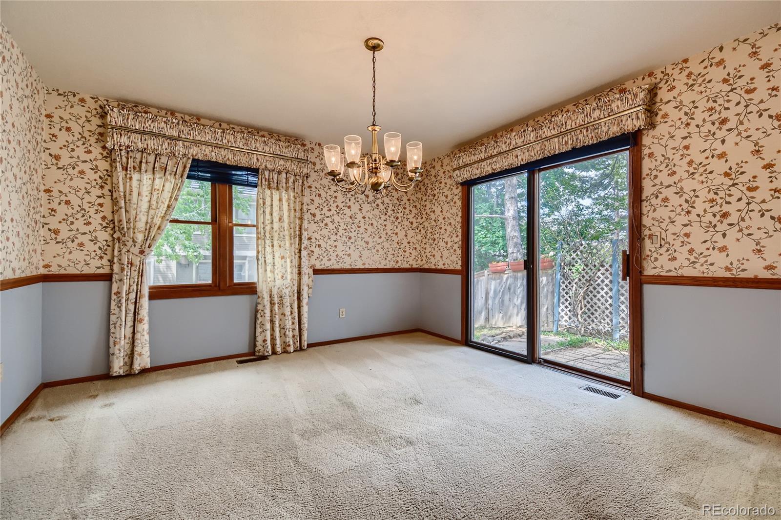 7 Red Maple Place Littleton, CO 80127 - Photo 6 of 28 an empty room with windows and entrance