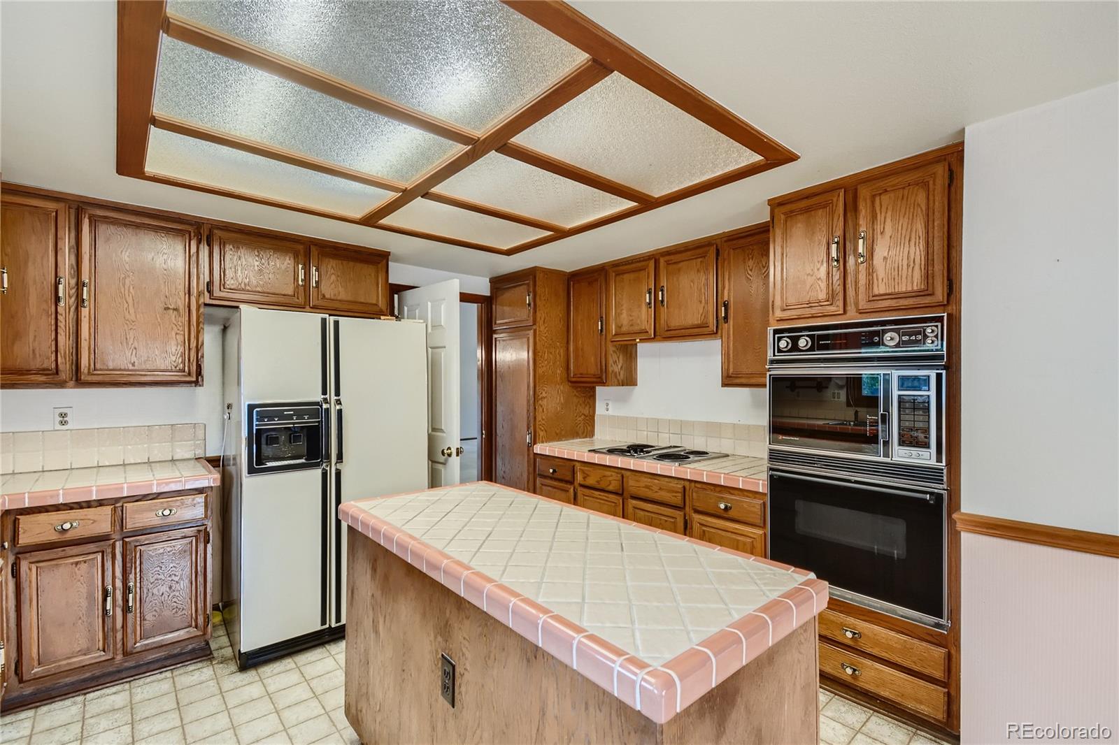 7 Red Maple Place Littleton, CO 80127 - Photo 7 of 28 a kitchen with stainless steel appliances granite countertop a refrigerator a stove and a sink