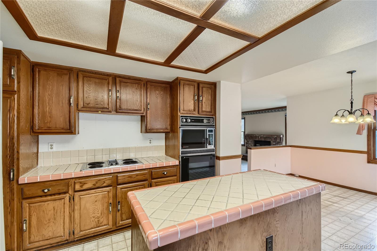 7 Red Maple Place Littleton, CO 80127 - Photo 8 of 28 a kitchen with cabinets and wooden floor