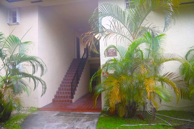 13714 Southwest 90th Avenue, Unit 25 Miami, FL 33176 - Photo 1 of 15 a close up of a palm plant in a garden