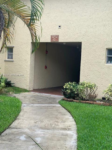 13714 Southwest 90th Avenue, Unit 25 Miami, FL 33176 - Photo 13 of 15 a front view of a house with a yard