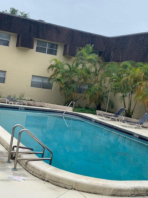 13714 Southwest 90th Avenue, Unit 25 Miami, FL 33176 - Photo 14 of 15 a backyard with table and chairs with potted plants