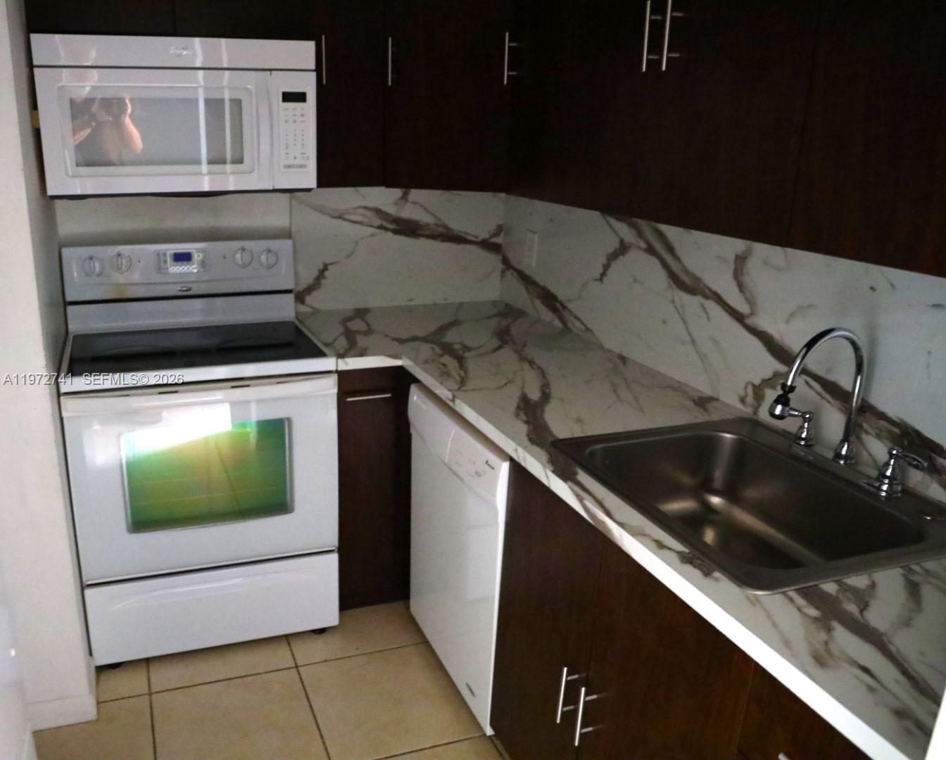13714 Southwest 90th Avenue, Unit 25 Miami, FL 33176 - Photo 2 of 15 a close view of a sink and a stove in a kitchen
