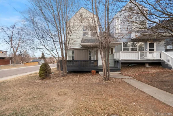 a view of house with yard porch and wooden fence