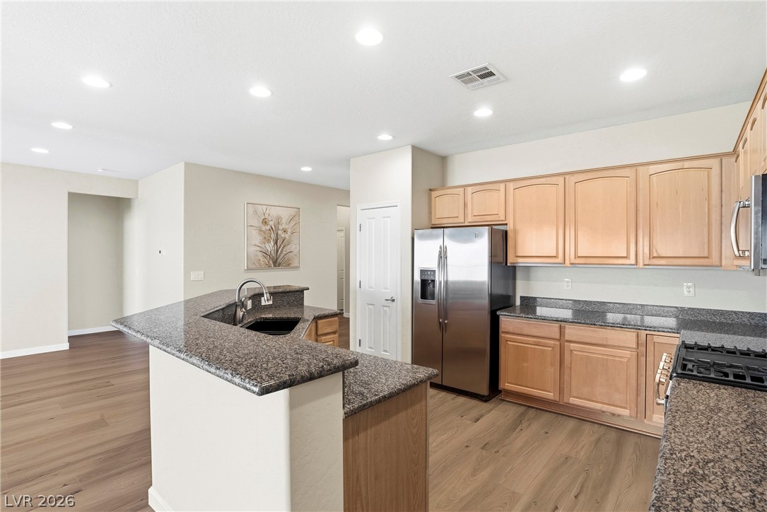 2541 Darda Street Henderson, NV 89044 - Photo 3 of 26 This spacious kitchen offers a large island with sink, ample cabinetry, and sleek appliances.