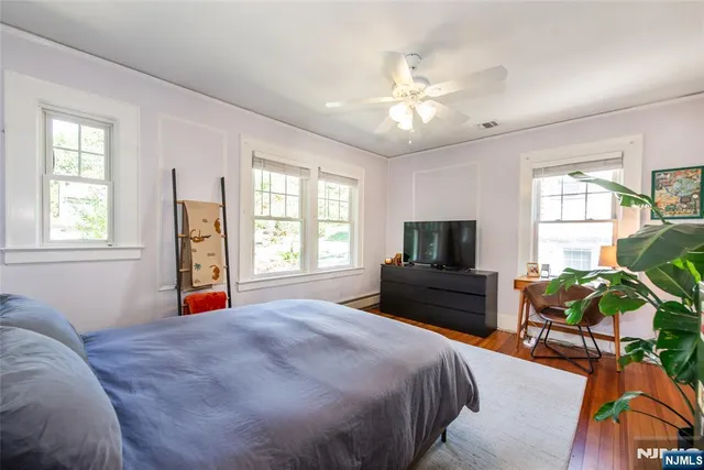 a spacious bedroom with a bed and a chandelier