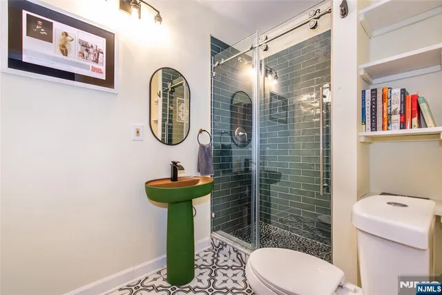 a bedroom with a bed and lamp next to a window