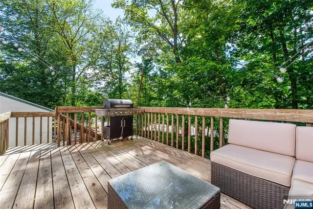 a balcony with wooden floor and furniture