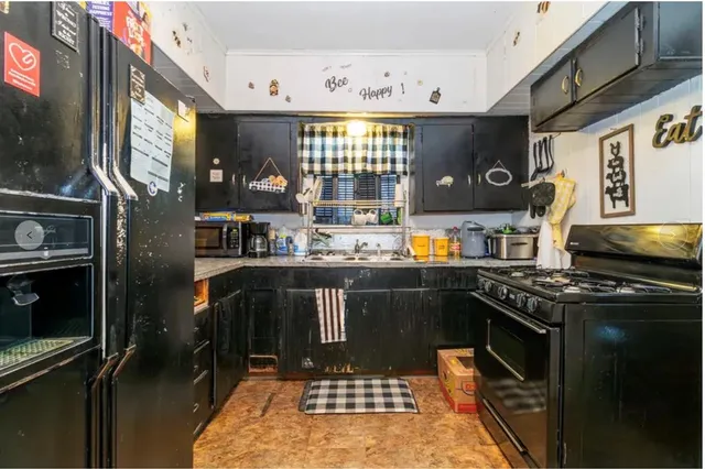 a kitchen with stainless steel appliances granite countertop a refrigerator and a sink