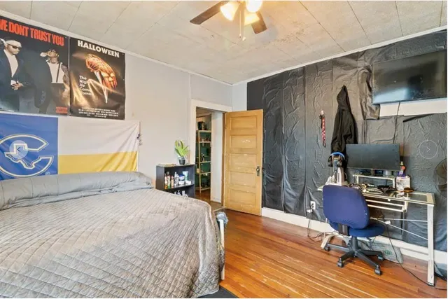 a bedroom with a bed and a chandelier