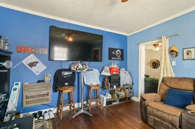 a living room with furniture and a flat screen tv