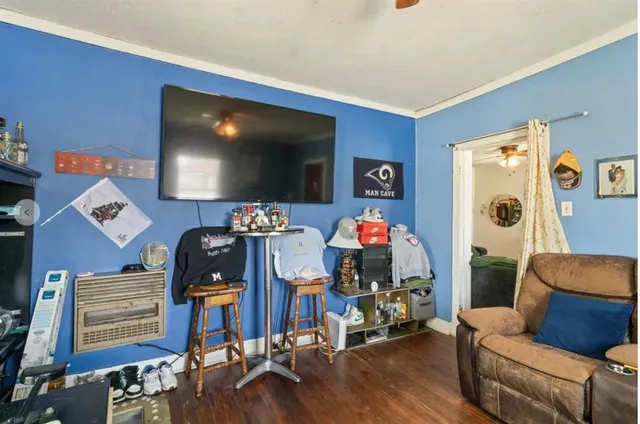 a living room with furniture a rug and a window