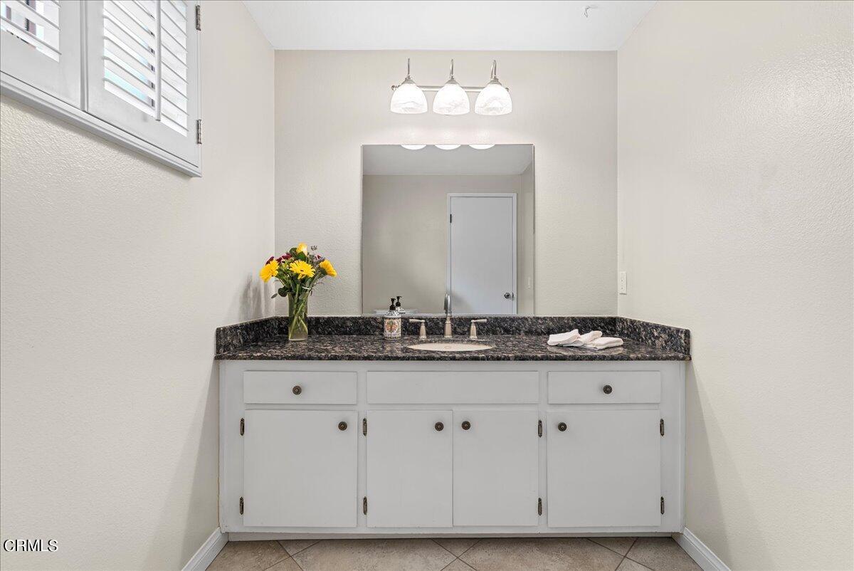 1143 Highland Avenue Duarte, CA 91010 - Photo 13 of 33 a bathroom with a granite countertop sink and a mirror