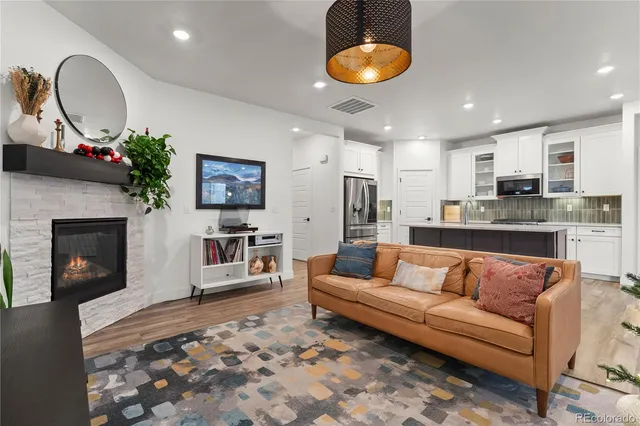a living room with furniture a fireplace and a flat screen tv