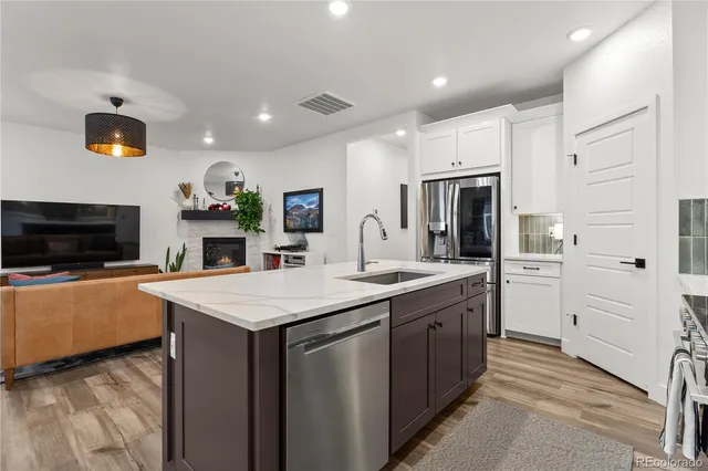 a kitchen with cabinets and stainless steel appliances