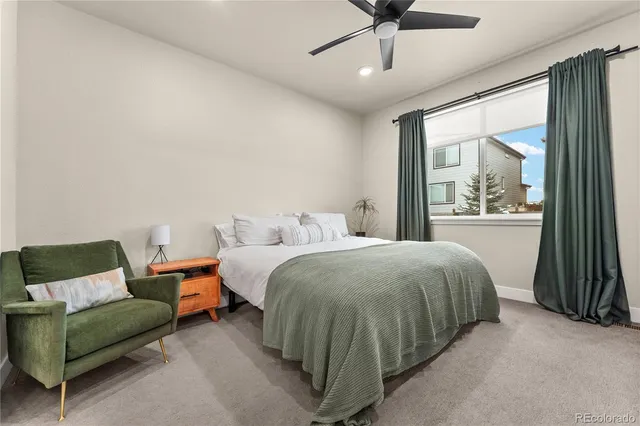 a spacious bedroom with a bed and window