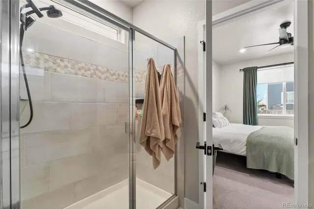 a en suite bathroom with a shower and a mirror