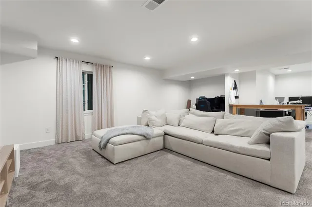 a living room with furniture and a large mirror