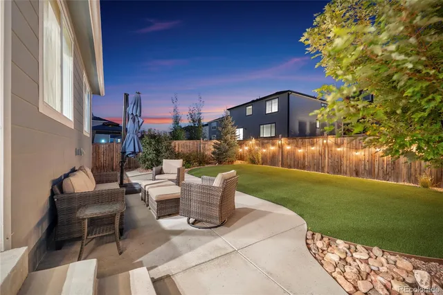 a view of a patio with couches table and chairs and potted plants