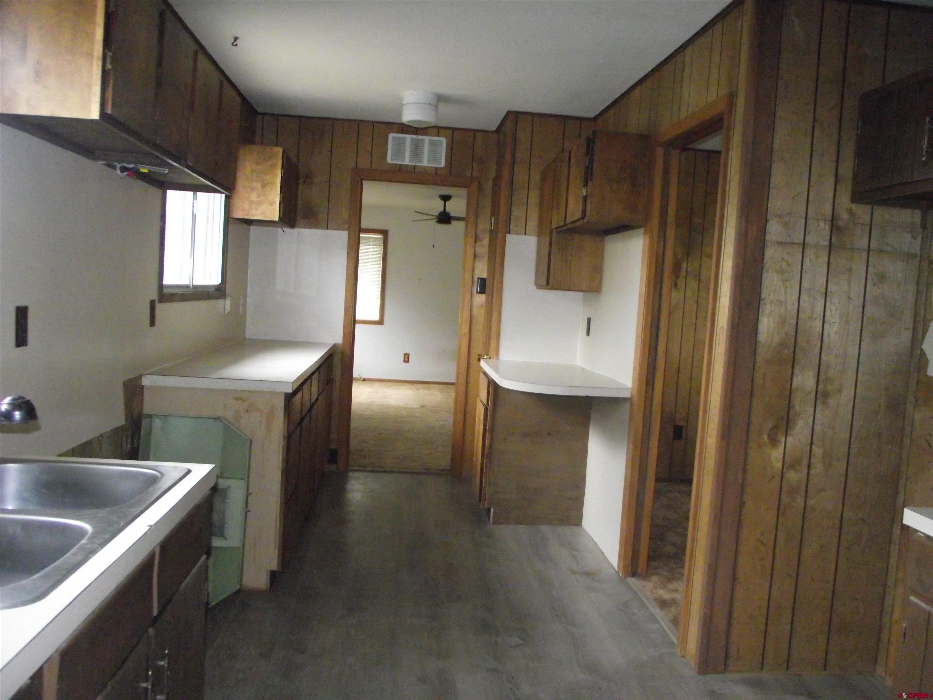 42996 Needle Rock Road Crawford, CO 81415 - Photo 22 of 45 a kitchen with a refrigerator and a sink